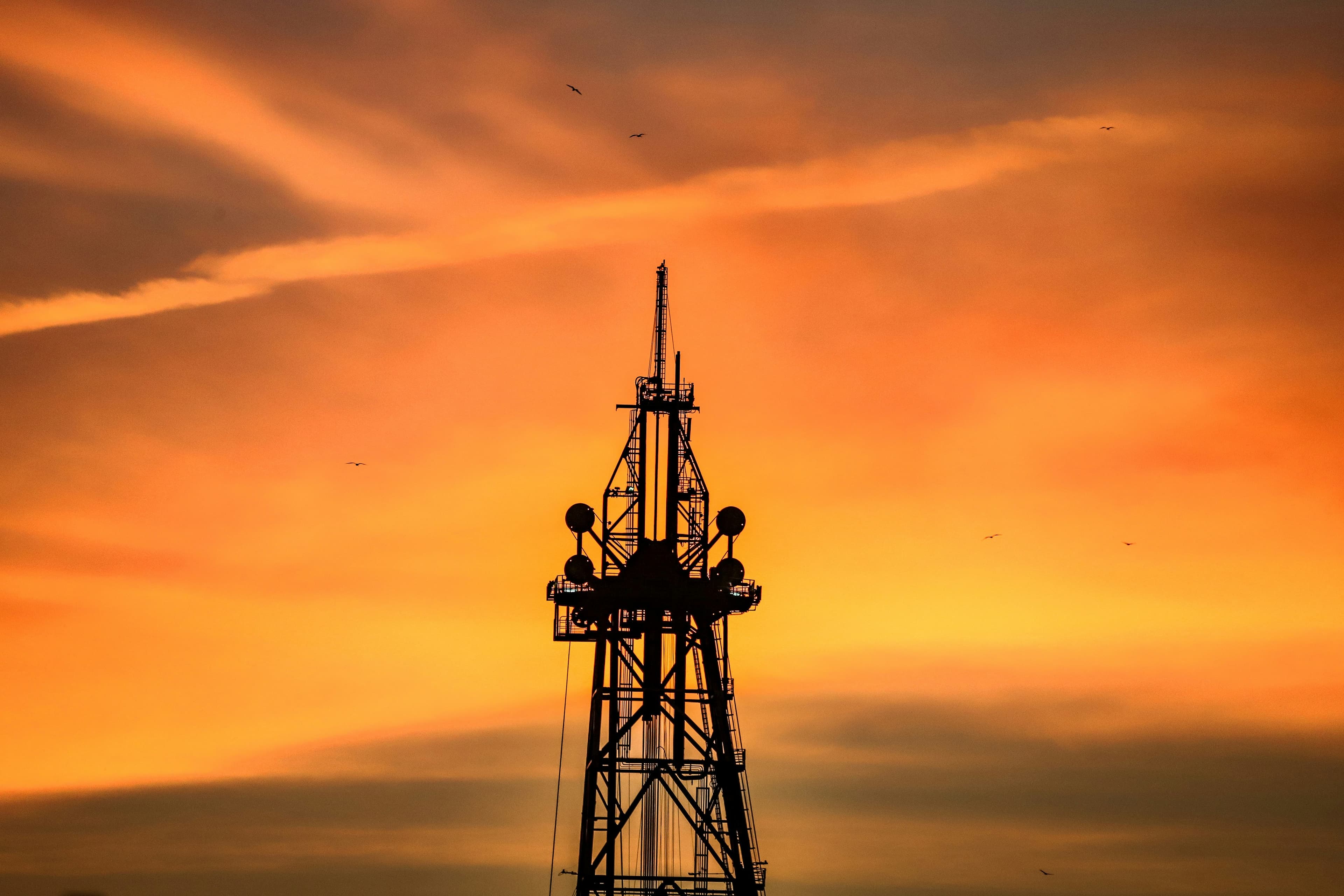 Telecom tower silhouette during sunset